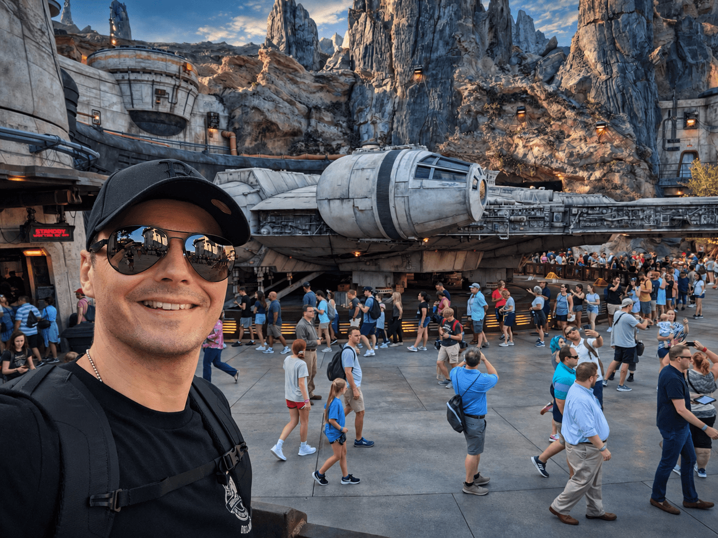 James in front of a Star Wars spaceship display in a themed outdoor setting.